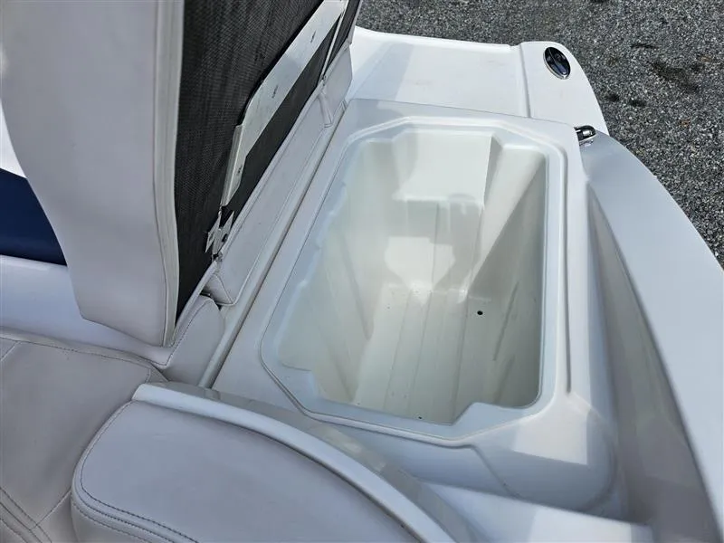 Slide: The Image of 2019 Chaparral 246 SSi boat storage compartment with open lid, showcasing interior space. - 30