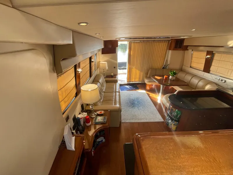 Slide: The Image of Interior of 2006 Carver 56 Voyager yacht, featuring luxurious seating and elegant decor. - 21