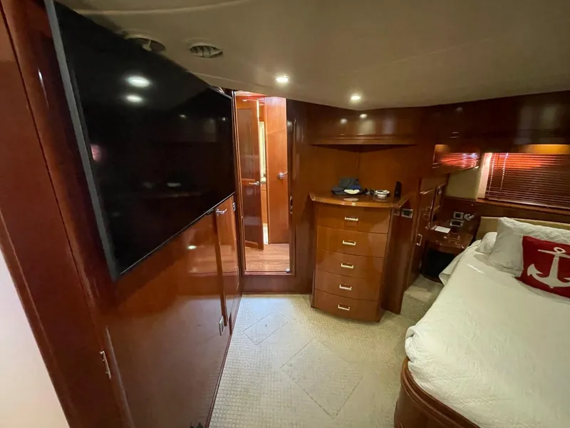 Slide: The Image of Interior of 2006 Carver 56 Voyager yacht bedroom with TV, bed, and wooden cabinetry. - 39