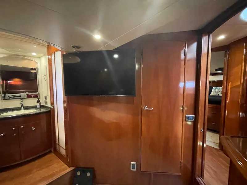 Slide: The Image of Interior of 2006 Carver 56 Voyager yacht with wood paneling and mounted TV. - 41