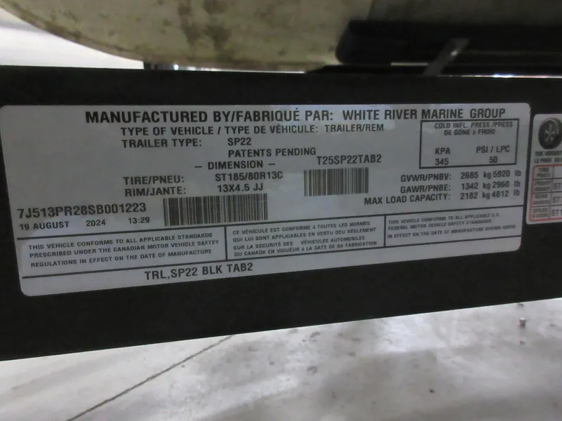 Slide: The Image of Label on Sun Tracker Party Barge 22 RF DLX trailer, detailing specifications and compliance information. - 11