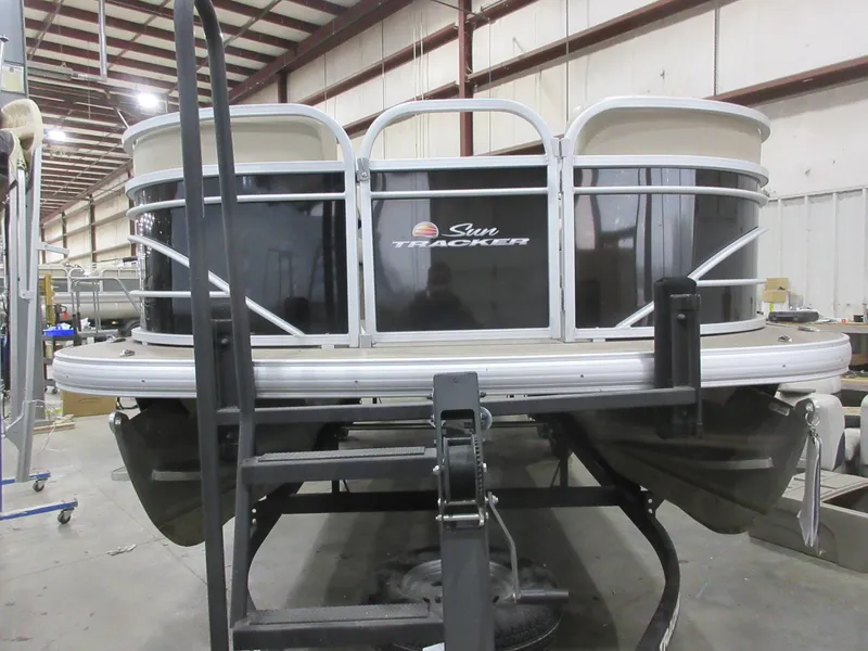Slide: The Image of 2022 Sun Tracker Party Barge 22 RF DLX pontoon boat in a warehouse setting. - 2