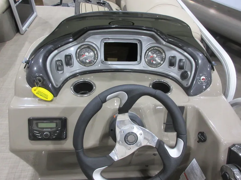 Slide: The Image of 2022 Sun Tracker Party Barge 22 RF DLX dashboard with steering wheel and controls. - 6
