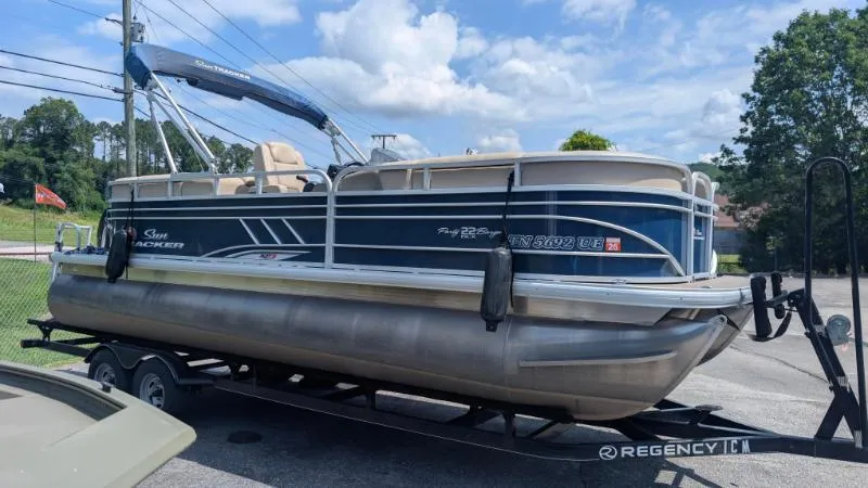 Slide: The Image of 2020 Sun Tracker Party Barge 22 RF XP3 pontoon boat on trailer, parked outdoors. - 11