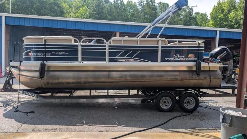Slide: The Image of 2020 Sun Tracker Party Barge 22 RF XP3 pontoon boat on trailer, parked outdoors. - 12