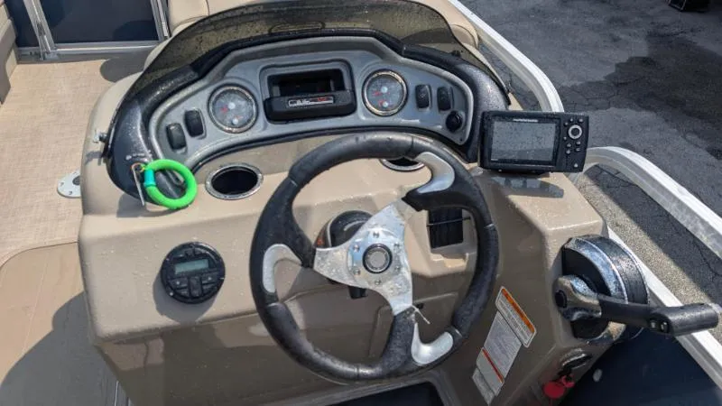 Slide: The Image of Steering console of 2020 Sun Tracker Party Barge 22 RF XP3 with gauges and controls. - 2