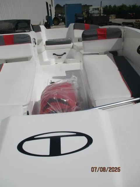 Slide: The Image of 2024 Tahoe T18 boat interior with red and gray seating, photographed outdoors. - 3