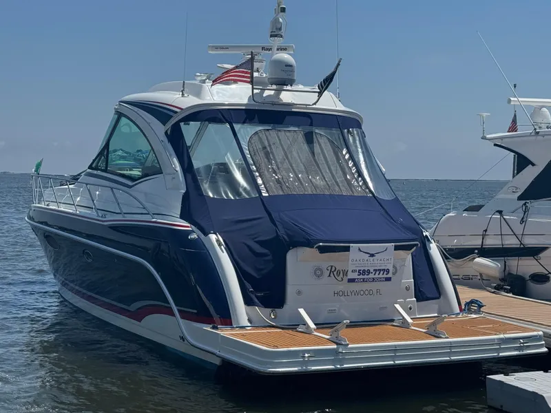 Slide: The Image of 2013 Formula 45 Yacht docked in Hollywood, FL, with blue cover and wooden deck. - 12