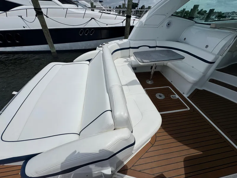 Slide: The Image of 2013 Formula 45 Yacht with white seating and wooden deck, docked at marina. - 17