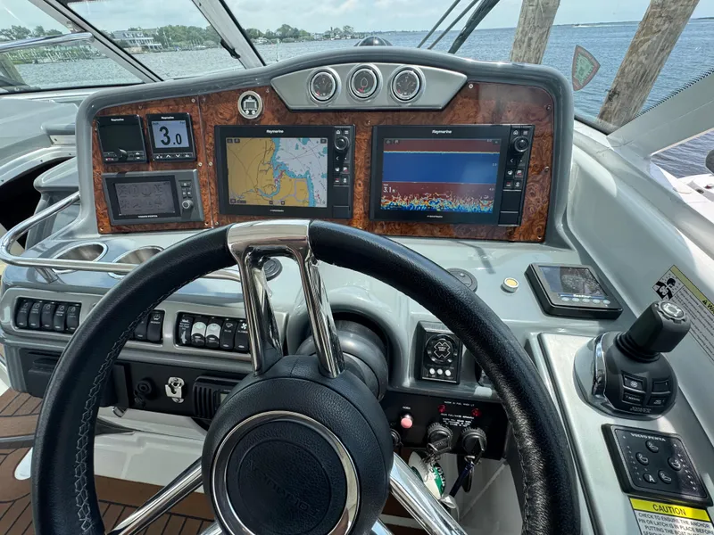Slide: The Image of Control panel of a 2013 Formula 45 Yacht with navigation screens and steering wheel. - 29