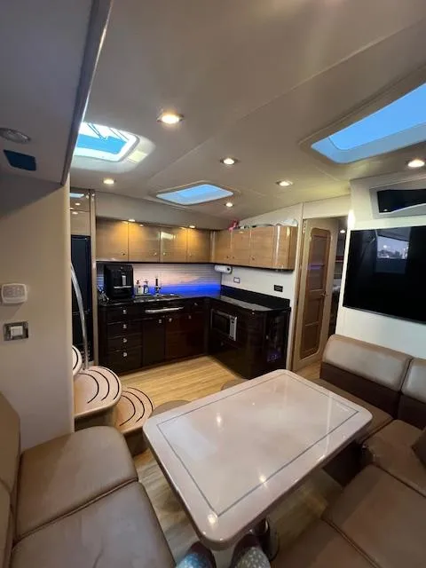 Slide: The Image of Interior of a 2013 Formula 45 Yacht featuring a modern kitchen and seating area. - 33