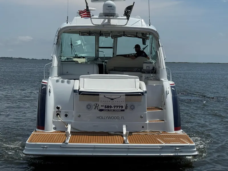 Slide: The Image of 2013 Formula 45 Yacht cruising on open water, rear view with American flag. - 6