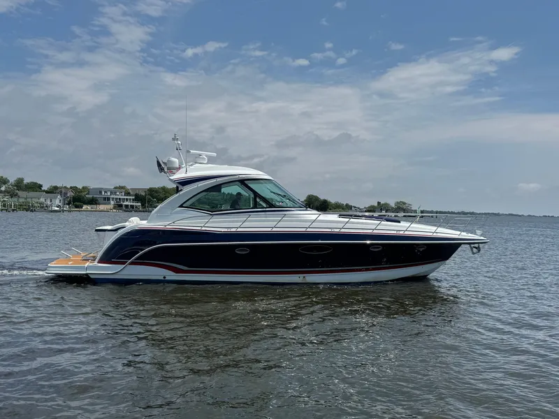Slide: The Image of 2013 Formula 45 Yacht cruising on a calm lake under a partly cloudy sky. - 9