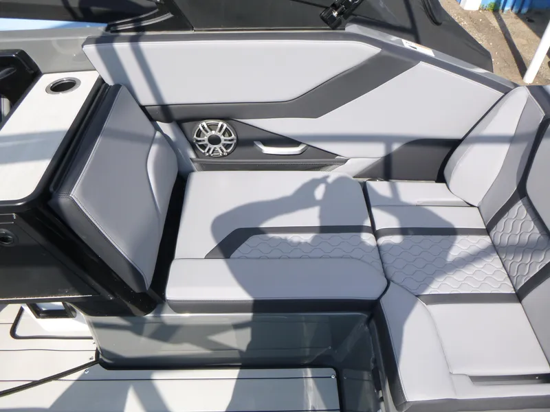Slide: The Image of 2025 Yamaha Boats 255XE interior seating with modern design and integrated speaker system. - 15