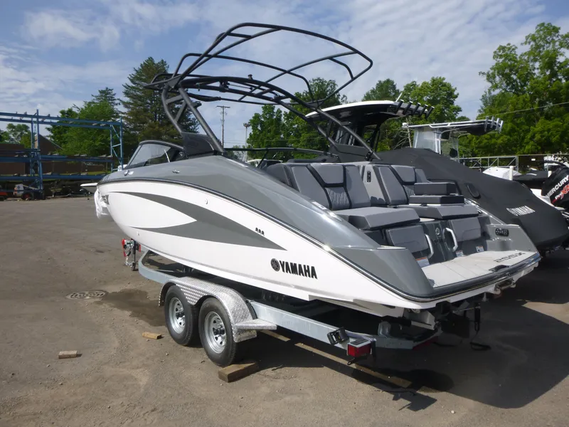 Slide: The Image of 2025 Yamaha Boats 255XE on trailer, sleek design, parked outdoors. - 3