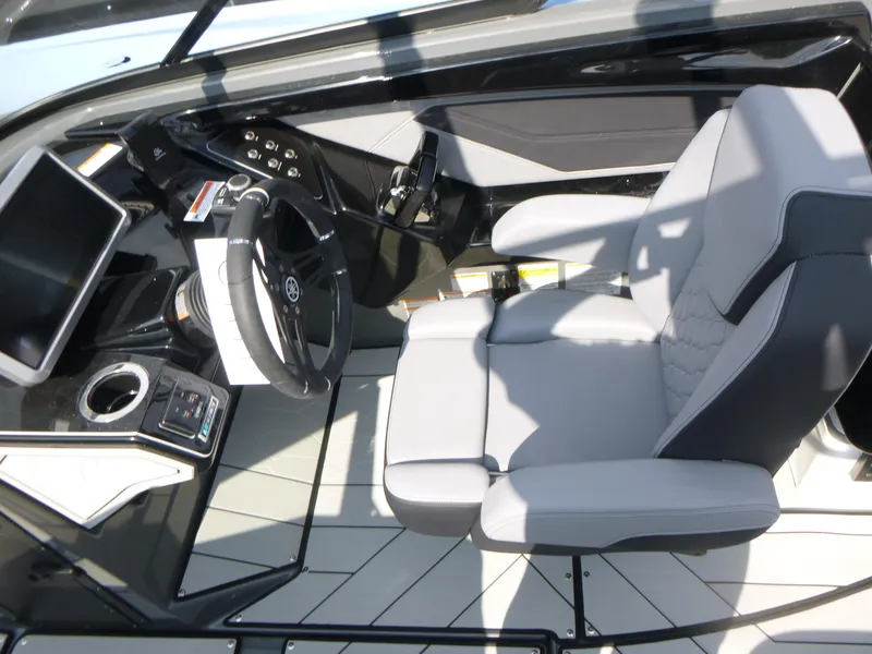 Slide: The Image of 2025 Yamaha Boats 255XE cockpit with modern steering wheel and comfortable seating. - 6
