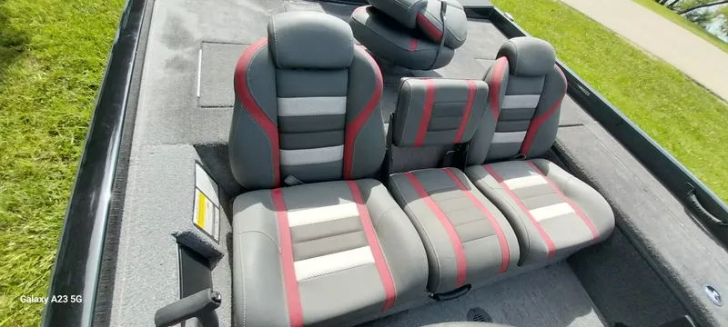 Slide: The Image of 2024 Ranger RT178C boat interior with gray and red cushioned seats. - 11