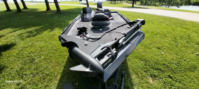 Slide: The Image of 2024 Ranger RT178C fishing boat on grass, featuring a trolling motor and spacious deck. - 19