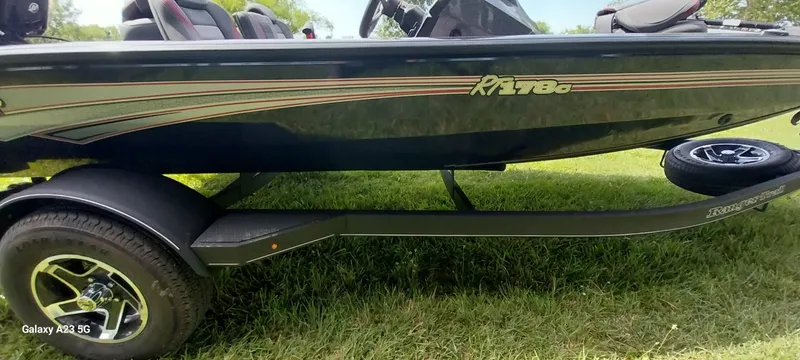 Slide: The Image of 2024 Ranger RT178C boat on trailer, parked on grass. - 2