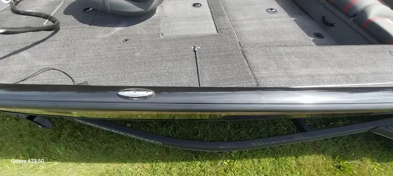 Slide: The Image of 2024 Ranger RT178C boat interior with gray carpet and seating, viewed from the side. - 24