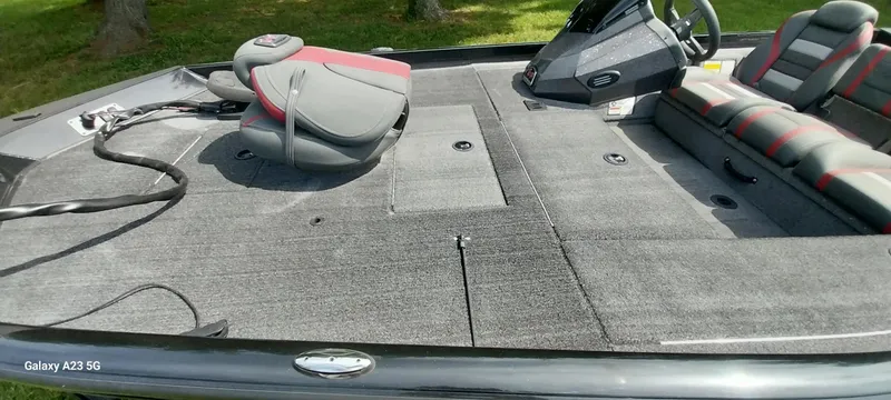 Slide: The Image of 2024 Ranger RT178C boat interior with gray carpet, seating, and steering console. - 25