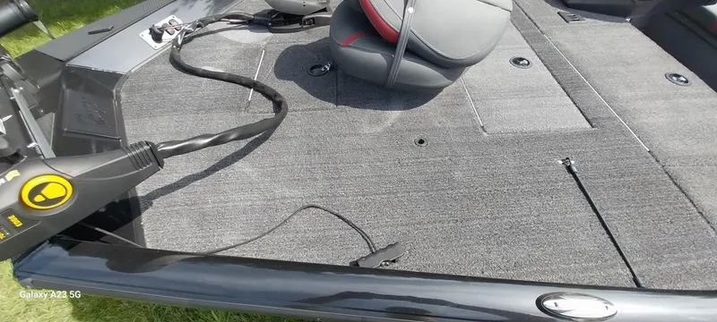 Slide: The Image of 2024 Ranger RT178C boat interior with gray carpet and seating. - 26