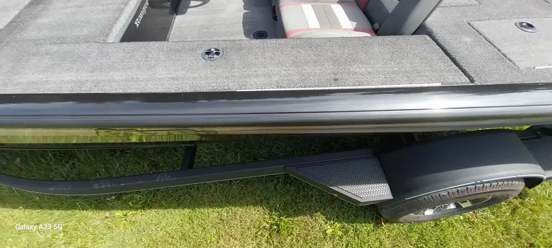 Slide: The Image of 2024 Ranger RT178C boat on trailer, gray interior, parked on grass. - 28