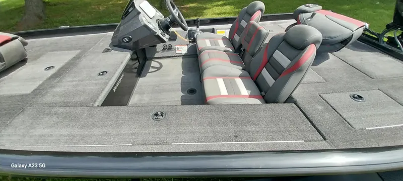 Slide: The Image of 2024 Ranger RT178C boat interior with gray and red seating, steering console, and spacious deck. - 29