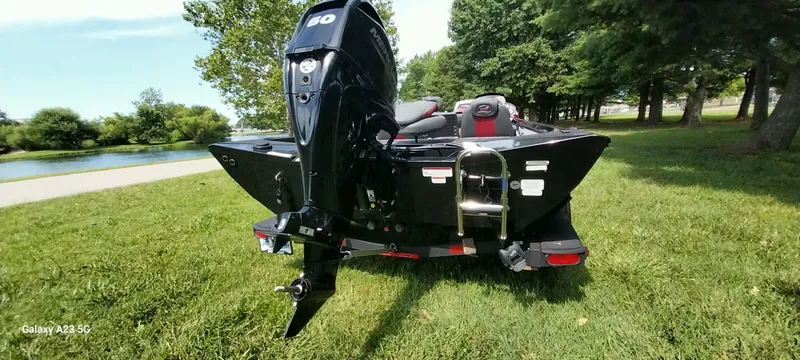 Slide: The Image of 2024 Ranger RT178C boat with outboard motor on grassy lakeside. - 3