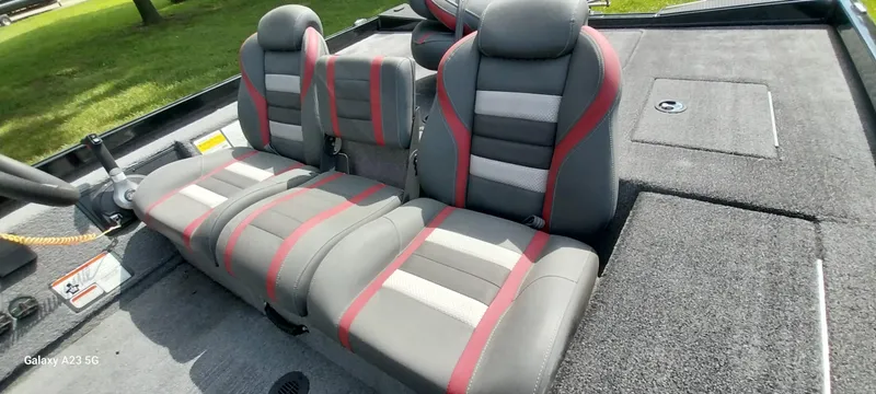 Slide: The Image of 2024 Ranger RT178C boat interior with gray and red seats, spacious layout. - 30