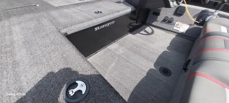 Slide: The Image of 2024 Ranger RT178C boat interior with carpeted flooring and seating. - 31