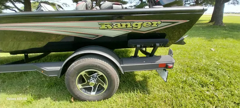 Slide: The Image of 2024 Ranger RT178C boat on trailer, parked on grass. - 32