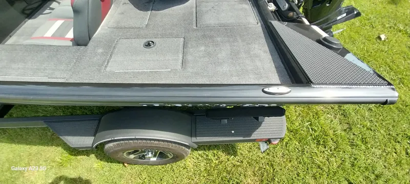 Slide: The Image of 2024 Ranger RT178C boat deck and trailer on grass. - 33