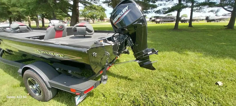 Slide: The Image of 2024 Ranger RT178C boat with Mercury engine on grassy area, surrounded by trees. - 35