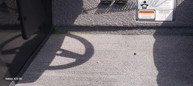 Slide: The Image of Interior of 2024 Ranger RT178C boat with textured flooring and warning label. - 37