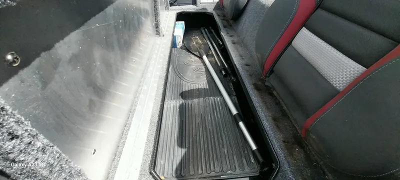 Slide: The Image of Storage compartment in 2024 Ranger RT178C boat with paddle and items. - 38