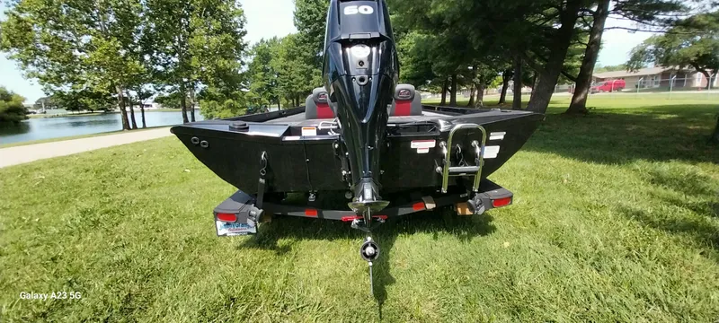 Slide: The Image of 2024 Ranger RT178C boat on grass near a lake, rear view. - 39