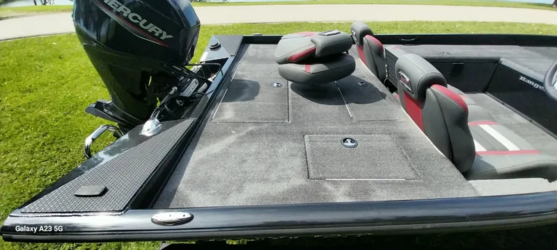 Slide: The Image of 2024 Ranger RT178C boat interior with Mercury engine, featuring seating and storage compartments. - 6