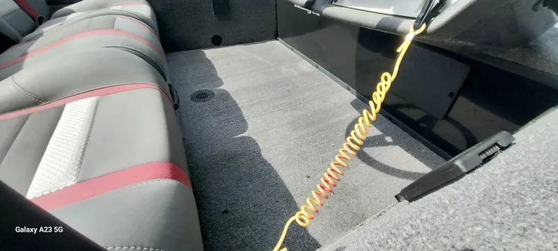 Slide: The Image of 2024 Ranger RT178C boat interior with gray and red seating, coiled yellow cable, and carpeted flooring. - 9