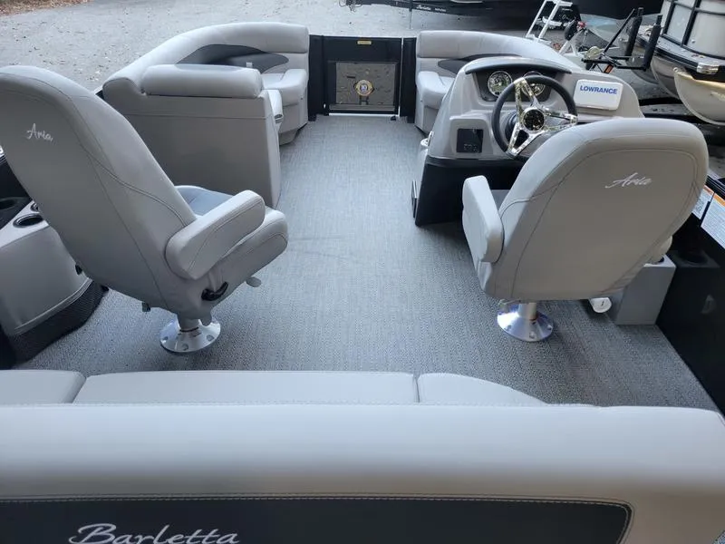 Slide: The Image of 2025 Barletta A20UC boat interior with gray seating and modern dashboard. - 15