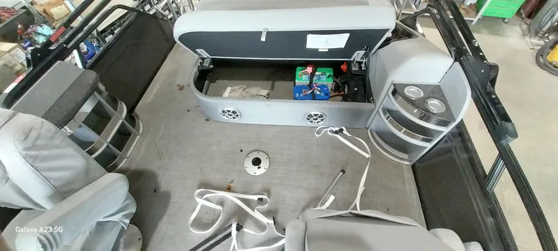 Slide: The Image of Interior of 2023 Regency 250 LE3 Sport boat with open storage and seating. - 10