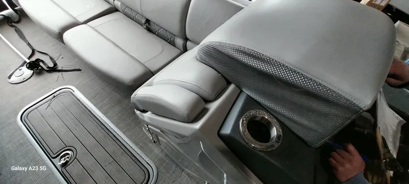 Slide: The Image of Interior of 2023 Regency 250 LE3 Sport boat with gray seating and cup holder. - 11