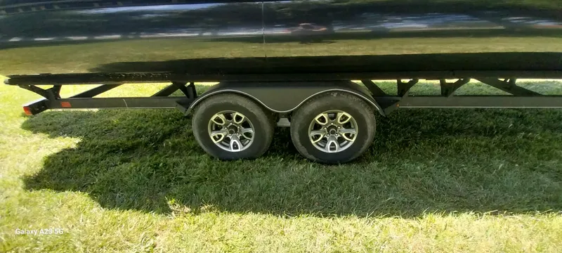 Slide: The Image of Trailer with dual wheels for 2023 Regency 250 LE3 Sport on grass. - 18