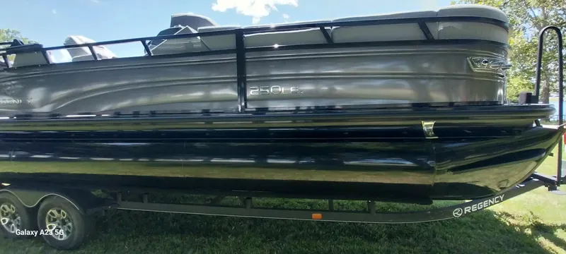Slide: The Image of 2023 Regency 250 LE3 Sport pontoon boat on trailer, side view. - 20