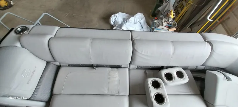 Slide: The Image of 2023 Regency 250 LE3 Sport boat interior with plush seating and cup holders. - 3