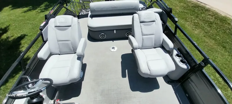 Slide: The Image of 2023 Regency 250 LE3 Sport boat interior with plush seating and steering wheel. - 34