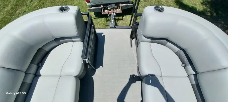 Slide: The Image of 2023 Regency 250 LE3 Sport boat interior with gray seating and cup holders. - 42