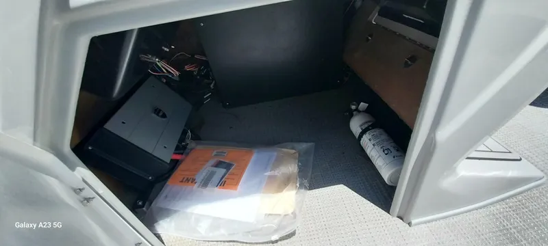 Slide: The Image of Storage compartment of 2023 Regency 250 LE3 Sport with documents and fire extinguisher. - 45