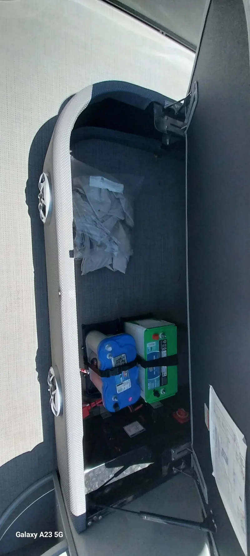 Slide: The Image of Storage compartment of 2023 Regency 250 LE3 Sport with batteries and equipment. - 46