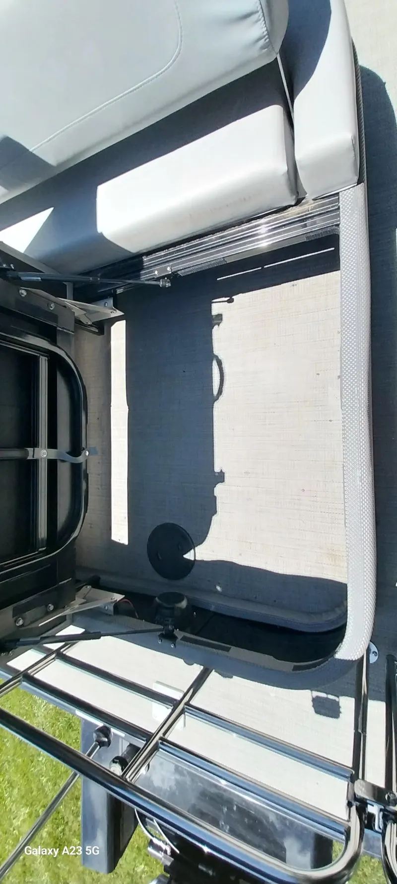 Slide: The Image of 2023 Regency 250 LE3 Sport boat interior with seating and railing, viewed from above. - 47